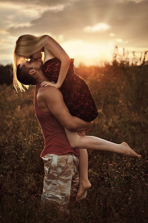 A couple sharing a captured moment in a field at sunset, with creative shots and photography tips.